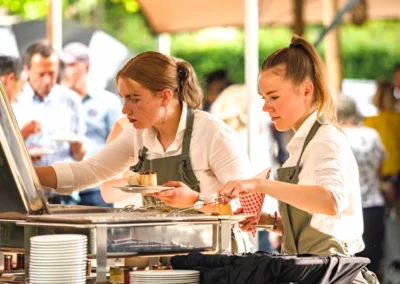 Bedienend personeel schept gerechten op tijdens een buffet bij een evenement